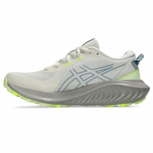 Side view of Asics trail running shoe with green sole.