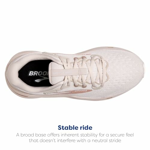 Top view of beige running shoe with stability feature.