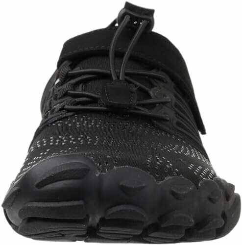 Front view of a black athletic shoe with textured sole