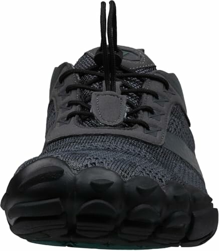 Front view of a black athletic shoe with textured sole