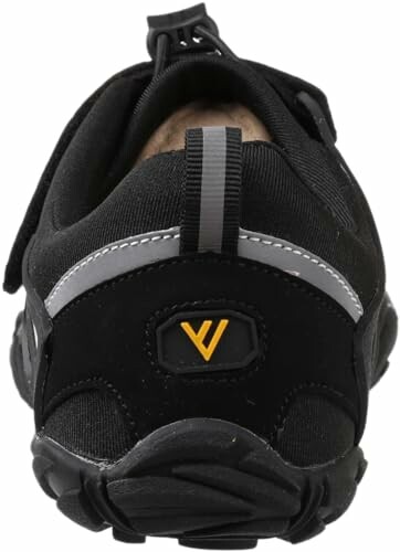 Back view of a black hiking shoe with yellow logo