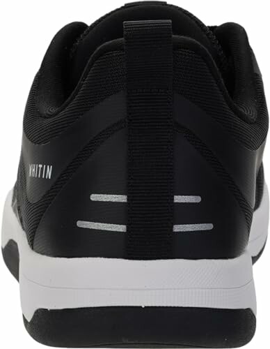 Back view of a black sneaker with white sole