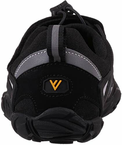 Back view of a black sports shoe with a yellow logo.