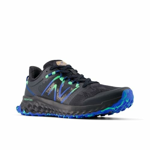 Black trail running shoes with blue and green accents.