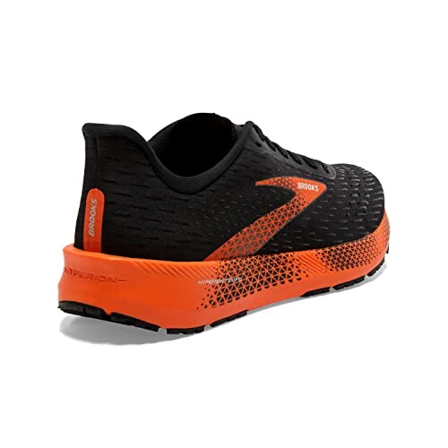 Black and orange Brooks running shoe, rear view.