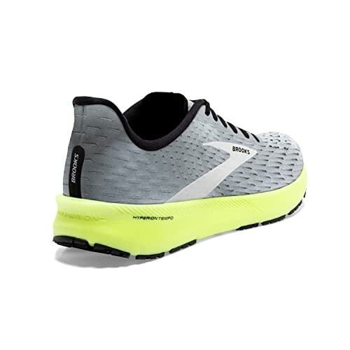 Side view of a Brooks running shoe with gray upper and neon yellow sole.