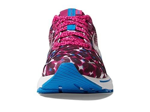 Front view of a colorful running shoe with pink and blue patterns.