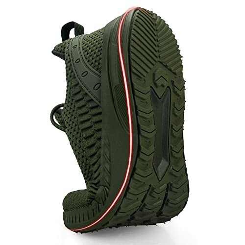 Green sneaker with flexible sole and textured tread.