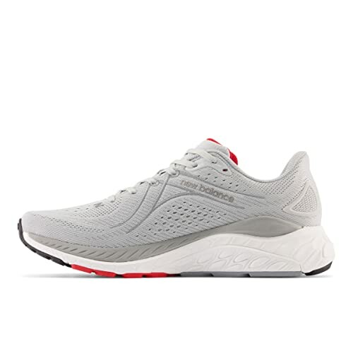 Gray New Balance running shoe with red accents.