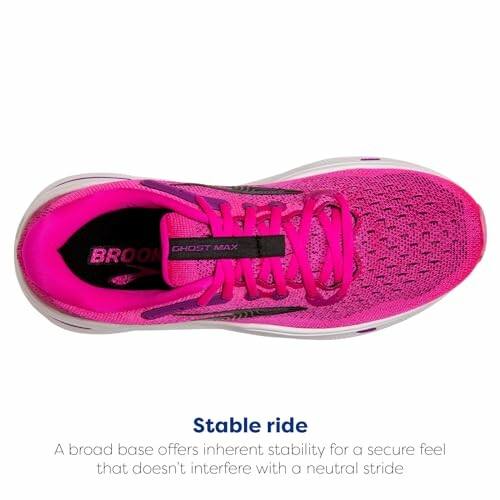 Top view of a pink running shoe with text about stability.