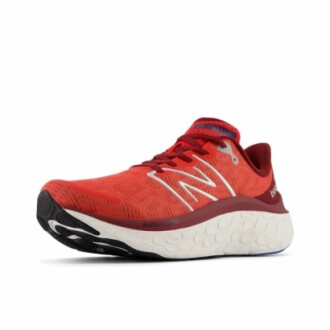 Red running shoe with white sole, side view