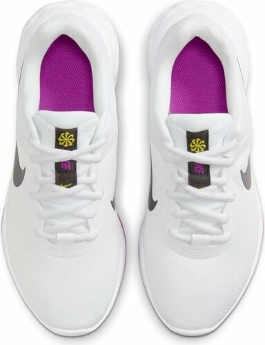 Top view of white sneakers with purple interior and black logo.